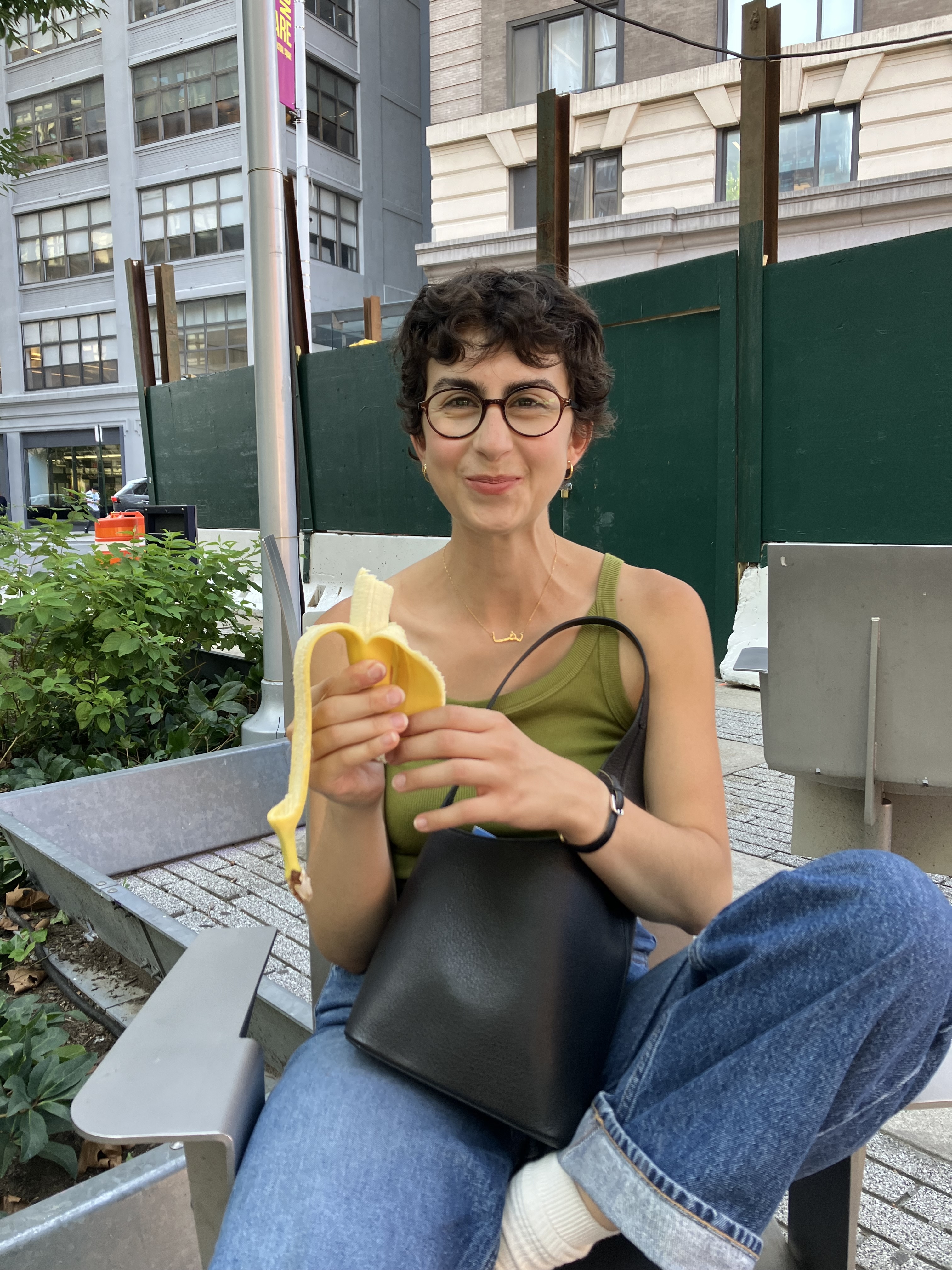 a picture of me eating a banana outside of trader joe's in nyc